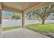 Covered patio offering a view of the backyard and mature tree at 14717 Royal Poinciana Dr, Orlando, FL 32828