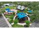 Aerial view of the community playground with colorful sunshades, picnic tables, and landscaping at 14717 Royal Poinciana Dr, Orlando, FL 32828