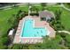 Aerial view of a community pool surrounded by lounge chairs and lush landscaping at 14717 Royal Poinciana Dr, Orlando, FL 32828