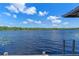 Scenic lake view from the deck with wooden posts and an abundant skyline at 18618 Lake Pickett Rd, Orlando, FL 32820