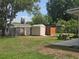 Open backyard with multiple sheds, wooden fence and picnic table at 217 Longleaf Ct, Orlando, FL 32835