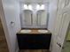 Bathroom featuring double sinks, dark wood cabinets, and modern fixtures at 217 Longleaf Ct, Orlando, FL 32835