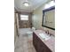 Bathroom with granite vanity, tiled shower and floors, and ample lighting for a spa-like experience at 217 Longleaf Ct, Orlando, FL 32835