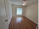 Bright bedroom featuring wood floors, ceiling fan, and closet, perfect for relaxation at 217 Longleaf Ct, Orlando, FL 32835