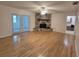 Spacious living room with hardwood floors, a stone fireplace and French doors leading outside at 217 Longleaf Ct, Orlando, FL 32835