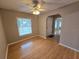 Bright living room with hardwood floors, natural light, ceiling fan and front door view at 217 Longleaf Ct, Orlando, FL 32835