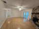 Inviting living room with hardwood floors, a ceiling fan, stone fireplace and natural lighting at 217 Longleaf Ct, Orlando, FL 32835