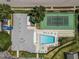 Aerial view of a pool, tennis court, and shuffleboard, all adjacent to a well-maintained clubhouse at 5813 Parkview Point Dr, Orlando, FL 32821