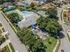 Aerial view of community clubhouse with a pool, tennis court, shuffleboard, parking, and mature trees at 5813 Parkview Point Dr, Orlando, FL 32821