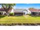 Home backyard featuring a screened porch, lush lawn, and a serene pond view at 5813 Parkview Point Dr, Orlando, FL 32821