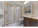 Modern bathroom featuring a glass-enclosed shower, dark cabinets, and updated fixtures at 5813 Parkview Point Dr, Orlando, FL 32821