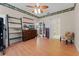 Spacious bedroom featuring wood floors, ceiling fan, dresser and open closet at 5813 Parkview Point Dr, Orlando, FL 32821