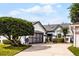 Charming single-story home featuring an attached garage, mature landscaping, and a well-manicured lawn at 5813 Parkview Point Dr, Orlando, FL 32821