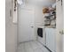 Functional laundry room with a washer, dryer, shelving, and tiled floors at 5813 Parkview Point Dr, Orlando, FL 32821