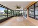 Relaxing screened patio with tile flooring overlooking a peaceful pond and lush greenery at 5813 Parkview Point Dr, Orlando, FL 32821
