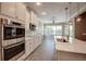 Bright kitchen features stainless appliances, white cabinetry, an island, and lots of natural light from large windows at 611 San Raphael St, Kissimmee, FL 34759