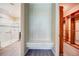 Walk-in closet with access to the bathroom and closet space with built-in shelving and a seating area at 611 San Raphael St, Kissimmee, FL 34759