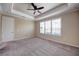 Open bedroom showing a ceiling fan, large windows with blinds, carpet, and neutral paint at 611 San Raphael St, Kissimmee, FL 34759