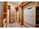 Custom wood walk-in closet with built-in shelving, drawers, and hanging rods for organized storage at 611 San Raphael St, Kissimmee, FL 34759