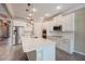 Modern kitchen features stainless steel appliances and a large center island with quartz countertops at 611 San Raphael St, Kissimmee, FL 34759