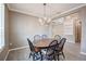 Well-lit dining area with a stylish chandelier adjacent to the entryway and living area at 611 San Raphael St, Kissimmee, FL 34759