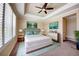 Spacious bedroom featuring a tray ceiling, a comfortable bed, a window, and two lovely art pieces at 611 San Raphael St, Kissimmee, FL 34759
