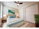Serene bedroom featuring a platform bed, modern décor, hardwood flooring and a bright sunny window at 611 San Raphael St, Kissimmee, FL 34759