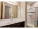 Bathroom featuring a sink with dark wood cabinets and shower/tub combo with decorative accent tiles at 611 San Raphael St, Kissimmee, FL 34759
