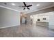 Open-concept living room with wood-style floors and crown molding provides a seamless flow at 611 San Raphael St, Kissimmee, FL 34759