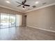 Spacious living room with tile floors and sliding glass doors that lead to the outdoor area at 611 San Raphael St, Kissimmee, FL 34759
