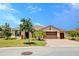 Charming single-story home showcasing a manicured lawn, large driveway, and well-maintained landscaping at 611 San Raphael St, Kissimmee, FL 34759