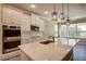 Beautiful kitchen with stainless appliances, tile backsplash, and a quartz-topped island at 611 San Raphael St, Kissimmee, FL 34759