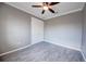 Bedroom showcasing flooring, a closet with double doors, a ceiling fan, and neutral paint at 611 San Raphael St, Kissimmee, FL 34759
