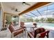 Screened-in patio with stylish furniture and ceiling fans overlooks a sparkling pool and lush greenery at 611 San Raphael St, Kissimmee, FL 34759