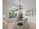 Bright dining room with round table set, accent rug, natural light, and modern chandelier at 8359 Grey Bark Ct, Sanford, FL 32771