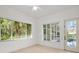 Airy living room with herringbone floors, and views of the pool through multiple windows at 8359 Grey Bark Ct, Sanford, FL 32771
