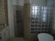Modern bathroom with soaking tub, glass block, and a shower at 2108 Northumbria Dr, Sanford, FL 32771