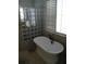 Bright bathroom features a soaking tub, glass block window, and stylish fixtures at 2108 Northumbria Dr, Sanford, FL 32771