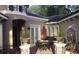 Private courtyard with outdoor seating, mature foliage, and elegant architectural details at 2108 Northumbria Dr, Sanford, FL 32771