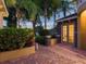 Paver courtyard featuring lush landscaping, brick accents, and double French doors leading to the interior at 2108 Northumbria Dr, Sanford, FL 32771