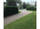 Long brick driveway lined with neatly trimmed hedges and a well-maintained lawn at 2108 Northumbria Dr, Sanford, FL 32771