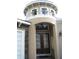 Charming turret entrance with custom doors, stone accents, and an arched transom window at 2108 Northumbria Dr, Sanford, FL 32771