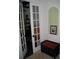 Inviting hallway entrance featuring a cushioned storage bench and glass paneled door at 2108 Northumbria Dr, Sanford, FL 32771