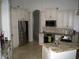 Well-lit kitchen featuring stainless appliances, granite counters, and custom cabinetry at 2108 Northumbria Dr, Sanford, FL 32771