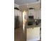 Spacious kitchen with stainless steel refrigerator, granite countertops, and custom cabinets at 2108 Northumbria Dr, Sanford, FL 32771
