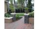 Beautiful landscaping features stone columns with plant urns, lush greenery, and a brick pathway at 2108 Northumbria Dr, Sanford, FL 32771