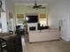 Bright living room has high ceilings, travertine floors, a fireplace, and views of the pool at 2108 Northumbria Dr, Sanford, FL 32771