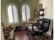 Home office with two windows, a desk and chair, and a neutral colored sofa at 2108 Northumbria Dr, Sanford, FL 32771