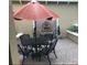 Private patio with wrought iron table and chairs and brick water feature at 2108 Northumbria Dr, Sanford, FL 32771