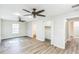 Spacious bedroom with wood-look vinyl flooring, ceiling fans, natural light, and closet with bifold doors at 250 E 20Th Ave, Mount Dora, FL 32757